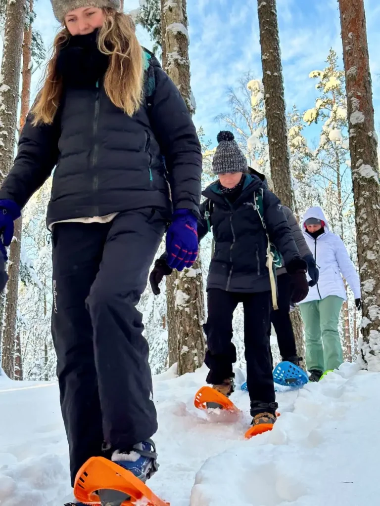 estonia snowshoe hiking group winter forest trail