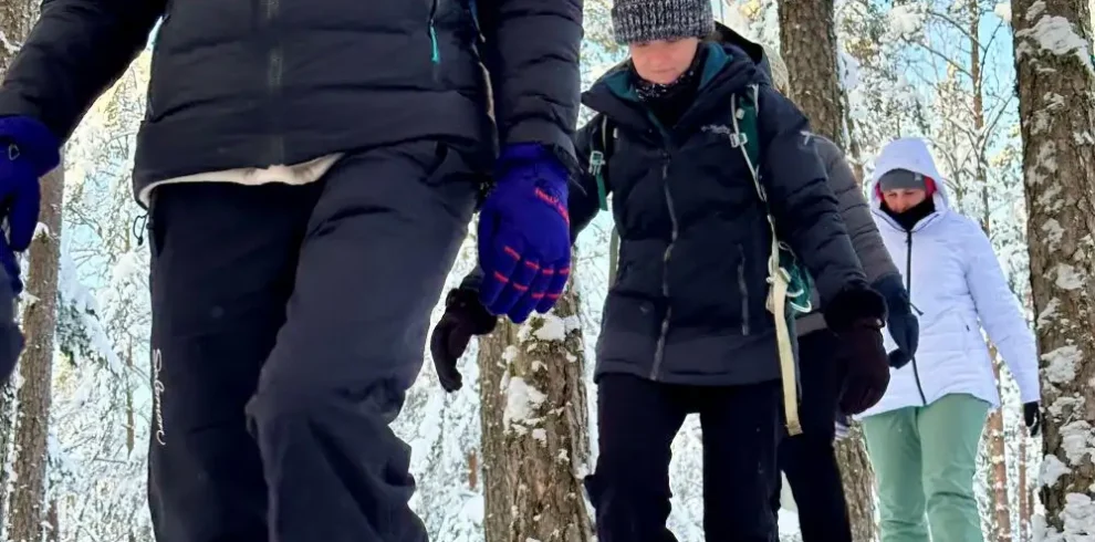 estonia snowshoe hiking group winter forest trail
